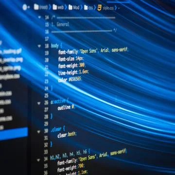 HTML and CSS code developing screenshot with light effects. Stock Photos