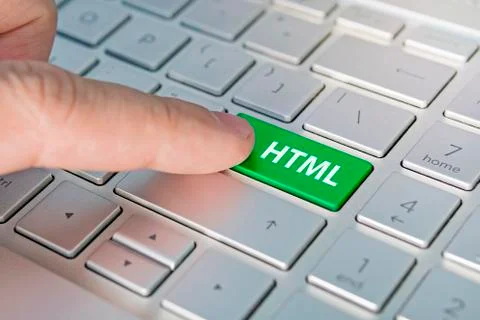 HTML computer language. writing on button modern of gray laptop. Finger press Stock Photos