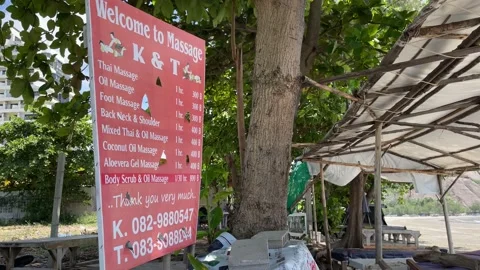 Hua Hin, Beachfront view sandy beach sunny. Landscape view massage sign blue sky Stock Footage 225122641