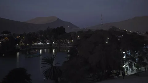 Huacachina oasis Peru desert at night Ica South America green waters lagoon Stock Footage 304102664