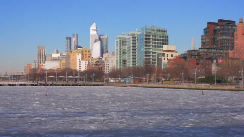 Hudson Yards skyscraper stands beyond frozen Hudson River in New York City. Stock Footage 300791829