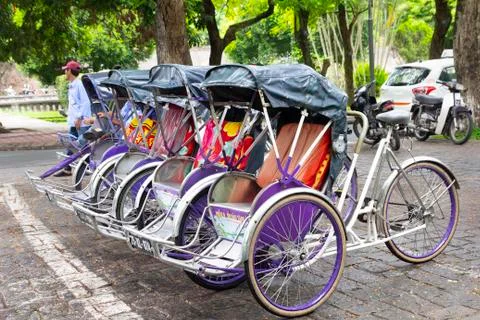 Hue, Vietnam - June 2017: riskshaws on street waiting for customer in Hue Stock Photos