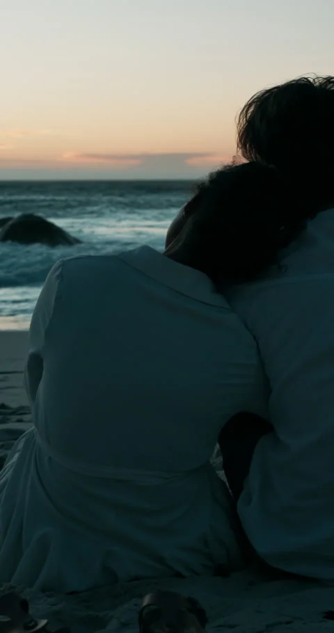 Hug, beach and back of couple at sunset for bonding, commitment and relationship Stockbeeldmateriaal 301953667