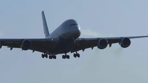 Huge airplane airbus 380 front view back lit arrival Stock Footage
