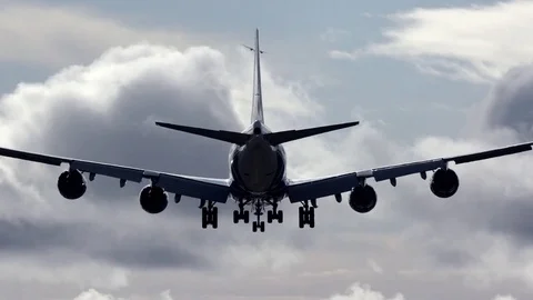 Huge airplane arrival runway silhouette rear view clouds background Stock Footage 80668523
