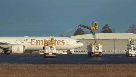 Huge airplane emirates boeing 777 approaching deice platform oslo airport Stock Footage