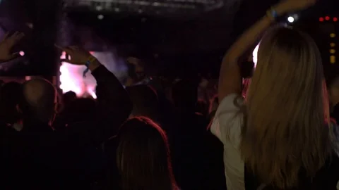 Huge amount of young people dancing jumping in front of concert musicians rock Stock Footage 118133466