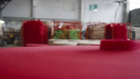 Huge amounts of textile material in rolls collected at a bag production facility Stock Footage 252488312