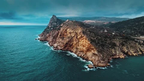 Huge ancient rocks washed by waves with white foam. Aerial view Stock Footage 148482365