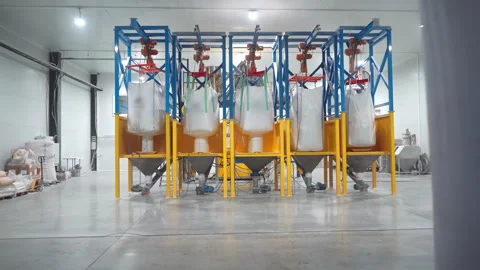 Huge bags with microplastic granules on rack for feeding at plant Video stock 304425795