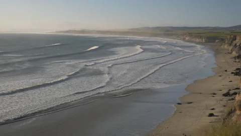 Huge beach with long waves at the edge of the cliffs, in New Zealand Stock Footage 219097149