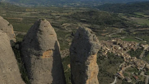 Huge bird circles as camera flies over rocks towards Aguero Stock Footage 102514437