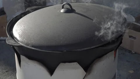 A huge black saucepan is boiling Stock Footage 87475627