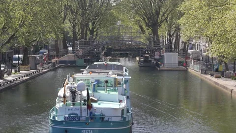 Huge boat passing under the bridge at Canal Saint-Martin in Paris, France Stock Footage 153759814
