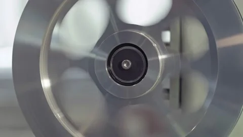 A huge bobbin unwinds a wire in a cable factory. Electrical, automated. Stock Footage 138046751