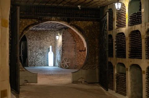 Huge bottle collection stored inside underground wine cellars tunnel Stock Photos