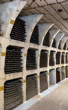 Huge bottle collection stored inside underground wine cellars tunnel Stock Photos