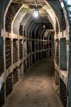 Huge bottle collection stored inside underground wine cellars tunnel Stock Photos