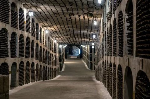 Huge bottle collection stored inside underground wine cellars tunnel Stock Photos