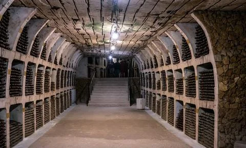 Huge bottle collection stored inside underground wine cellars tunnel Stock Photos