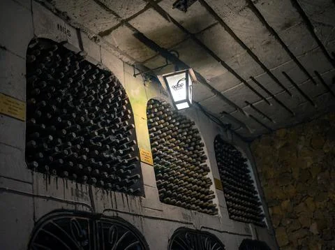 Huge bottle collection stored inside underground wine cellars tunnel Stock Photos