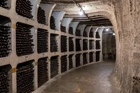 Huge bottle collection stored inside underground wine cellars tunnel Stock Photos