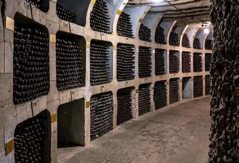 Huge bottle collection stored inside underground wine cellars tunnel Stock Photos