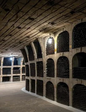 Huge bottle collection stored inside underground wine cellars tunnel Stock Photos