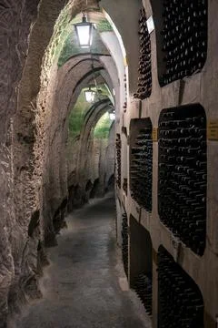 Huge bottle collection stored inside underground wine cellars tunnel Stock Photos