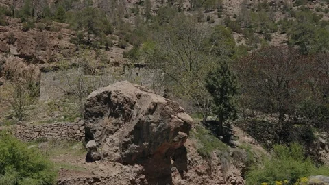 Huge Boulder Below Stone Houses and Dry Terraces on a Mountain Slope Video stock 342329918