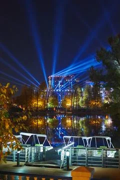 Huge bright powerful spotlight rays over in the night sky over the autumn p.. Stock Photos