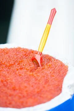 Huge bucket of red caviar on table 写真素材