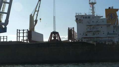 Huge bulk carrier loaded by floating crane. Stock Footage 130064104