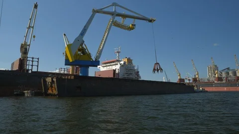 Huge bulk carrier loaded by floating crane. Stock Footage 130064162