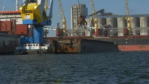 Huge bulk carrier loaded by floating crane. Stock Footage 130064221