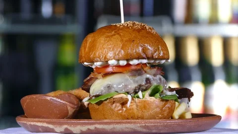 Huge burger spinning on a rotating table in pub Stock-Footage 88730968