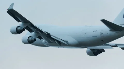 Huge cargo airplane boeing 747 cal jumbo jet passing rear view slow motion Stock Footage 221642603