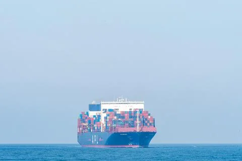A huge Cargo Ship ariving int the Harbour of Rotterdam. Stock Photos