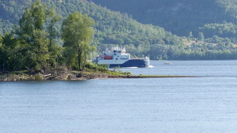 A huge cargo ship is going down the river. A wide navigable river. Stock Footage 188281282