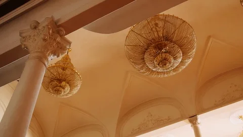 Huge chandeliers hang on the ceiling . closeup shot of an elegant and beautiful  Stock Footage 121571634