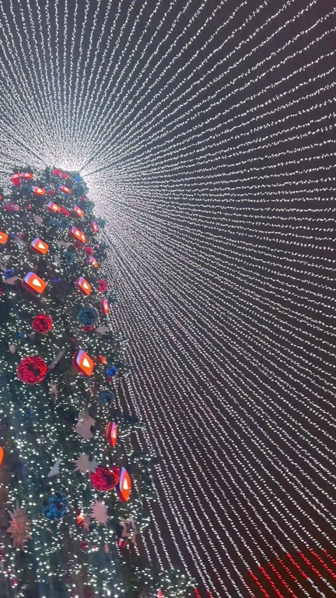 Huge Christmas festive tree and lights at night in in the city square. Stock Footage 294266150