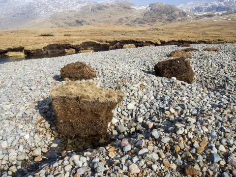 Huge chunks of peat eroded from the side of the Upper Esk by extreme flooding Stock Photos