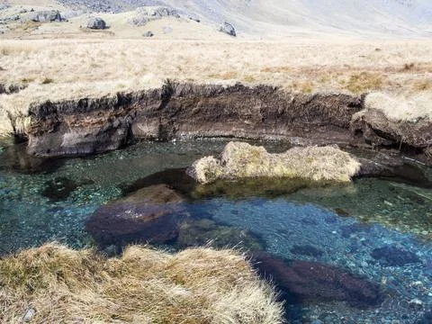 Huge chunks of peat eroded from the side of the Upper Esk by extreme flooding Stock Photos