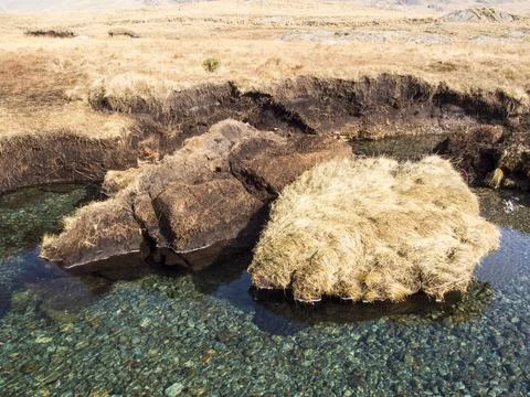 Huge chunks of peat eroded from the side of the Upper Esk by extreme flooding Stock Photos