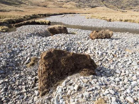 Huge chunks of peat eroded from the side of the Upper Esk by extreme flooding Stock Photos