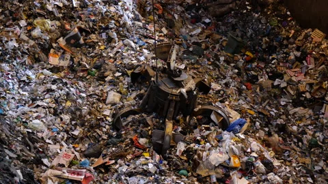 A huge claw grabs a portion of garbage for delivery to the oven.  Stock Footage 234680425