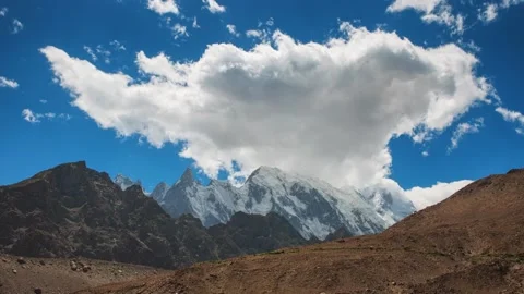 Huge cloud over snowy peaks Stock Footage 196804777