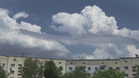Huge clouds fly over high-rise buildings. Swallows fly around. Stock Footage 110808215