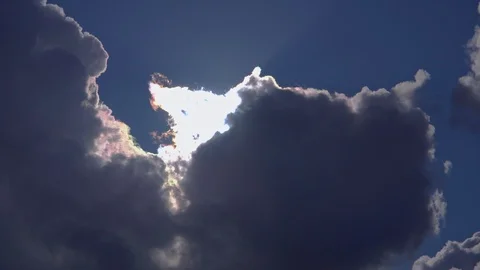 Huge clouds sky and the sun behind in the blue sky Stock Footage 105350756