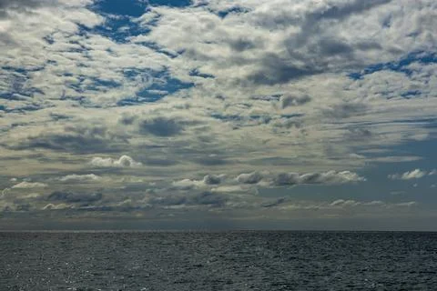 A huge cloudy sky filled with thick cumulus clouds creating a dramatic spec.. Stock Photos